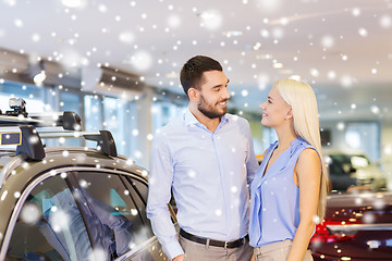 Image showing happy couple buying car in auto show or salon