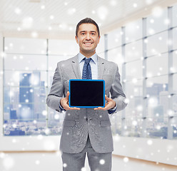 Image showing happy businessman in suit showing tablet pc screen