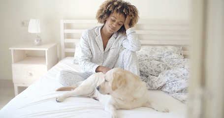 Image showing Woman And Her Dog Resting In Bed