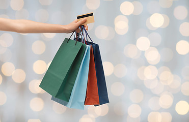 Image showing close up of woman with shopping bags and bank card