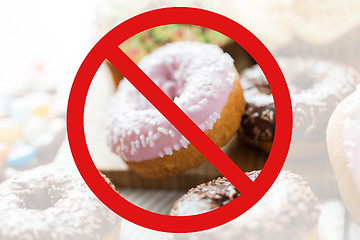 Image showing close up of glazed donuts pile behind no symbol