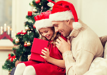 Image showing smiling father and daughter opening gift box