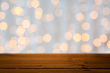 Image showing empty wooden table with christmas golden lights