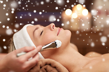 Image showing woman face and beautician applying mask in spa