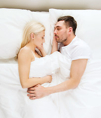 Image showing happy couple sleeping in bed at home