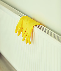 Image showing close up of rubber gloves hanging on heater