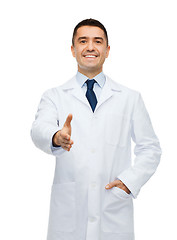 Image showing smiling male doctor in white coat givin hand