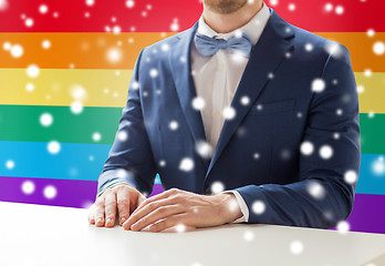 Image showing close up of man in suit and bow-tie at table