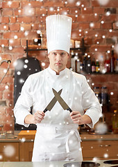 Image showing happy male chef cook in kitchen with knife