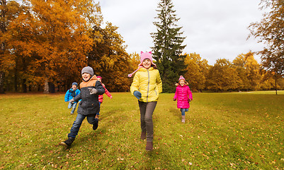 Image showing group of happy little kids running outdoors