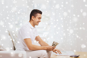 Image showing man with papers and calculator counting money