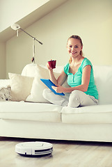 Image showing happy woman with tablet pc drinking tea at home