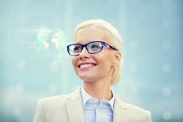 Image showing young smiling businesswoman in eyeglasses outdoors