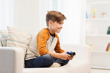 Image showing happy boy with joystick playing video game at home