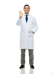 Image showing smiling doctor in white coat showing ok hand sign