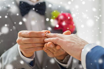 Image showing close up of male gay couple hands and wedding ring