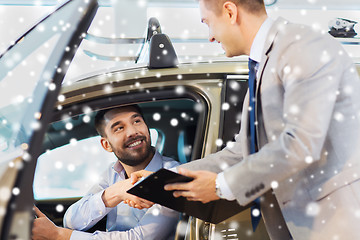 Image showing happy man with car dealer in auto show or salon