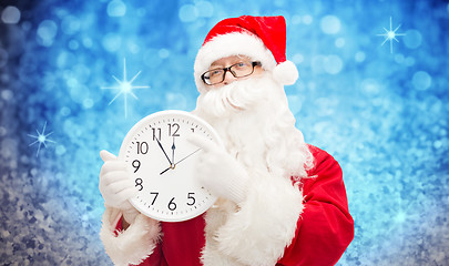 Image showing man in costume of santa claus with clock