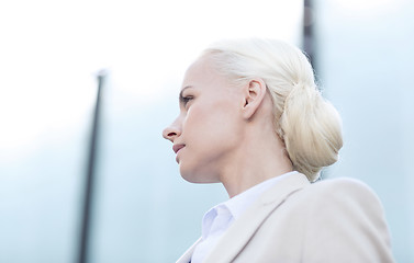 Image showing young businesswoman over office building