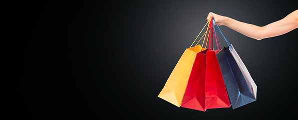 Image showing close up of hand holding shopping bags