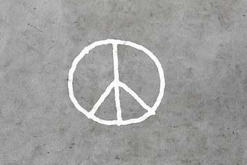 Image showing peace sign drawing on gray concrete wall