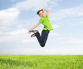Image showing smiling boy jumping in air