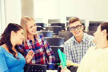 Image showing group of smiling students with notebook