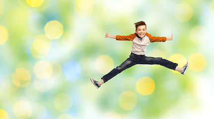 Image showing happy smiling boy jumping in air