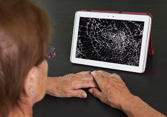 Image showing Senior lady with tablet, cracked screen