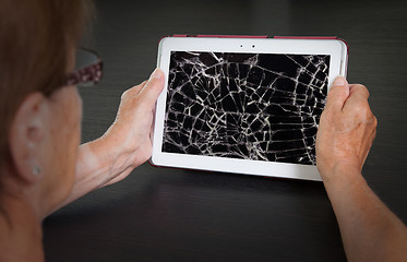 Image showing Senior lady with tablet, cracked screen