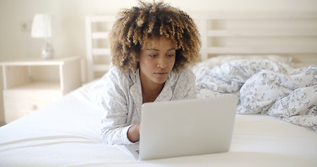 Image showing Woman Looking At Laptop In Bed At Home