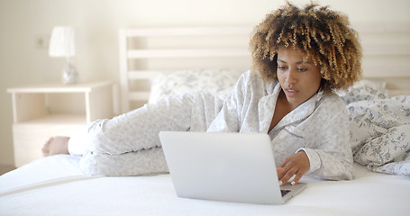 Image showing Cute Woman Using Laptop On Bed.