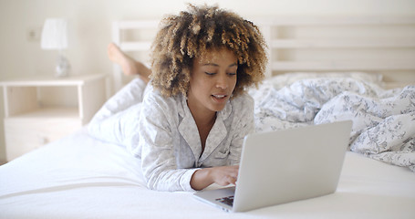 Image showing Woman Looking At Laptop In Bed At Home