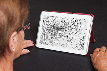 Image showing Senior lady with tablet, cracked screen