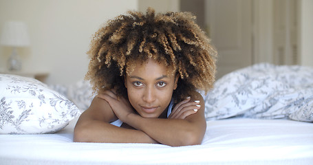 Image showing Cute woman lying on bed at home in bedroom