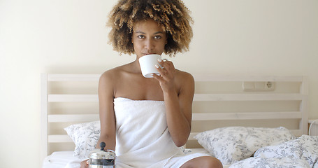 Image showing Attractive Woman With A Cup Of Coffee On The Bed