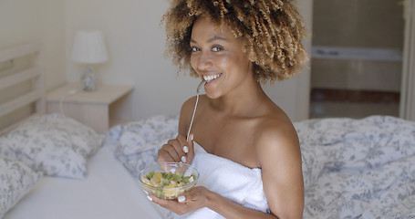 Image showing Young Woman On Bed Eating Vegetable Salad