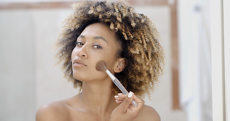 Image showing Young Woman Putting Make Up