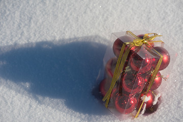 Image showing christmas ball in box on fresh  snow