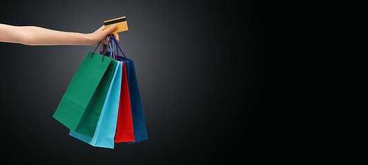 Image showing close up of woman with shopping bags and bank card