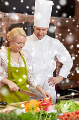 Image showing happy male chef cook with woman cooking in kitchen