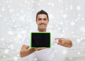 Image showing smiling man showing tablet pc blank screen at home