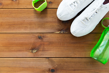 Image showing close up of sneakers, bracelet and water bottle