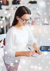 Image showing smiling woman with tablet pc at cafe