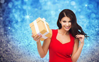 Image showing beautiful sexy woman in red dress with gift box