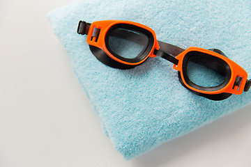 Image showing close up of swimming goggles and towel