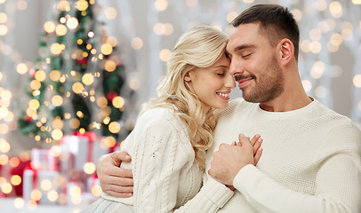 Image showing happy couple over christmas tree lights background