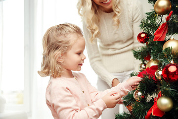 Image showing happy family decorating christmas tree at home