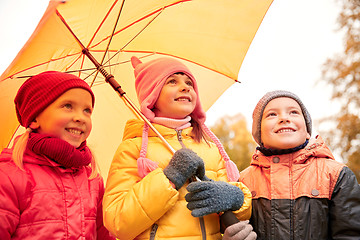 Image showing happy children with umbrella in autumn park