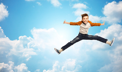 Image showing happy smiling boy jumping in air